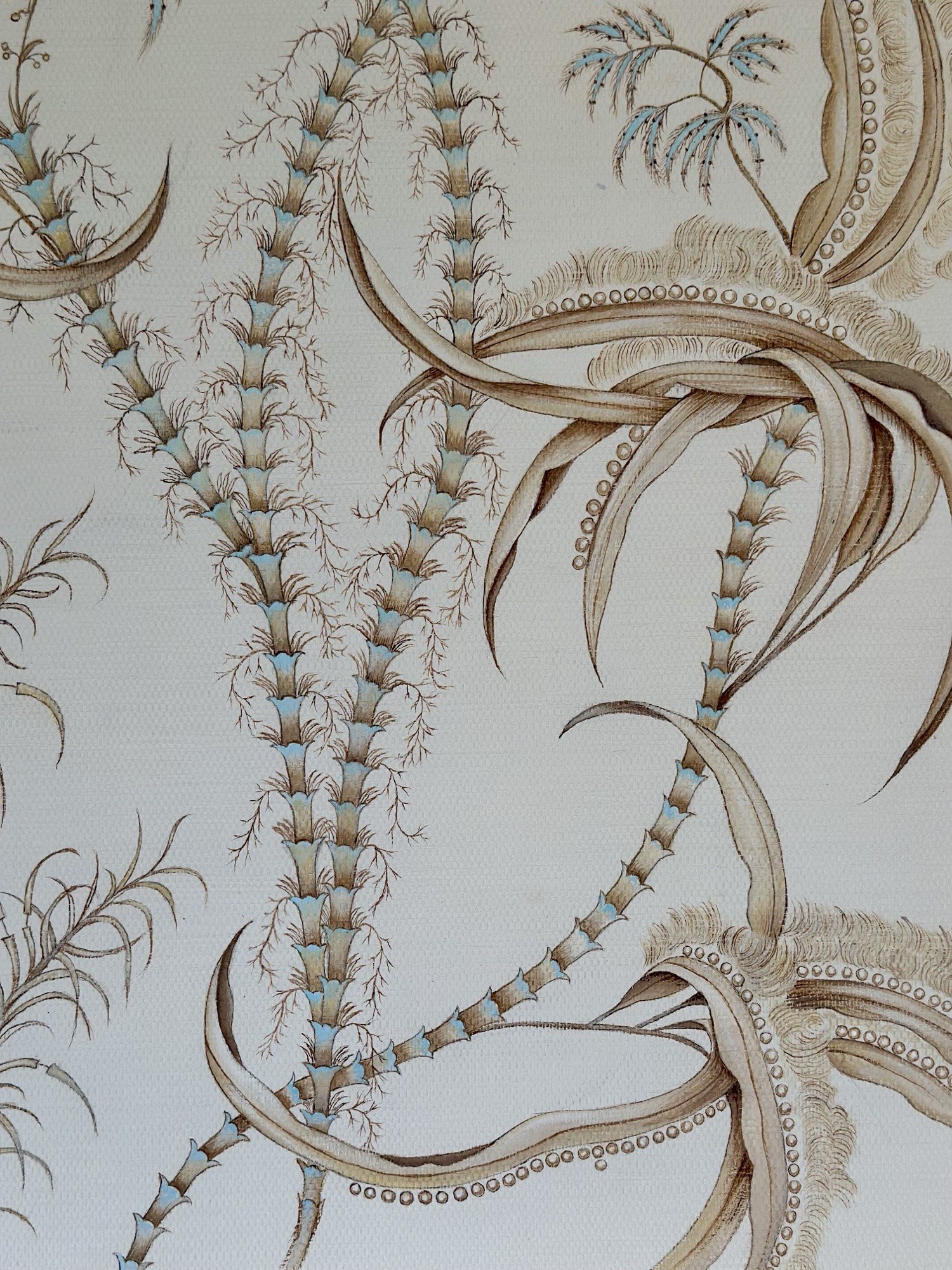 Hand-painted grass cloth wallpaper detail with botanical sprigs and blue accents by Kim Delaney, Delaney Fine Finishes