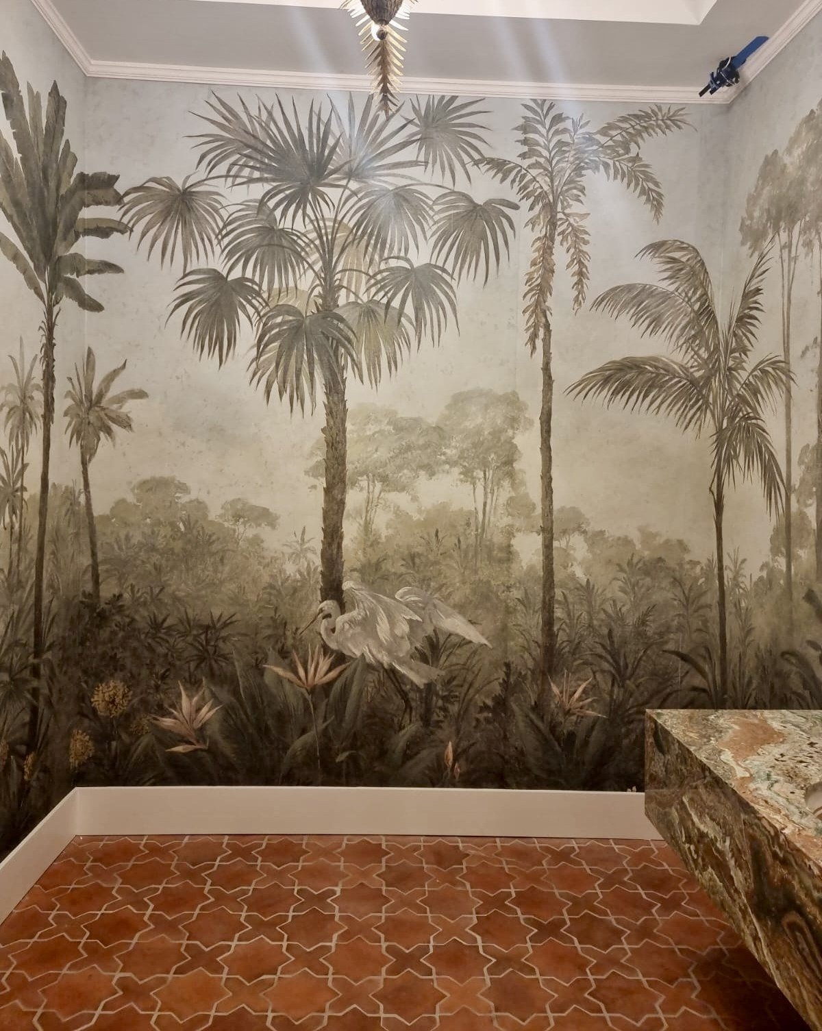 Hand-painted jungle mural with white egret wrapping a powder room by Kim Delaney, Delaney Fine Finishes