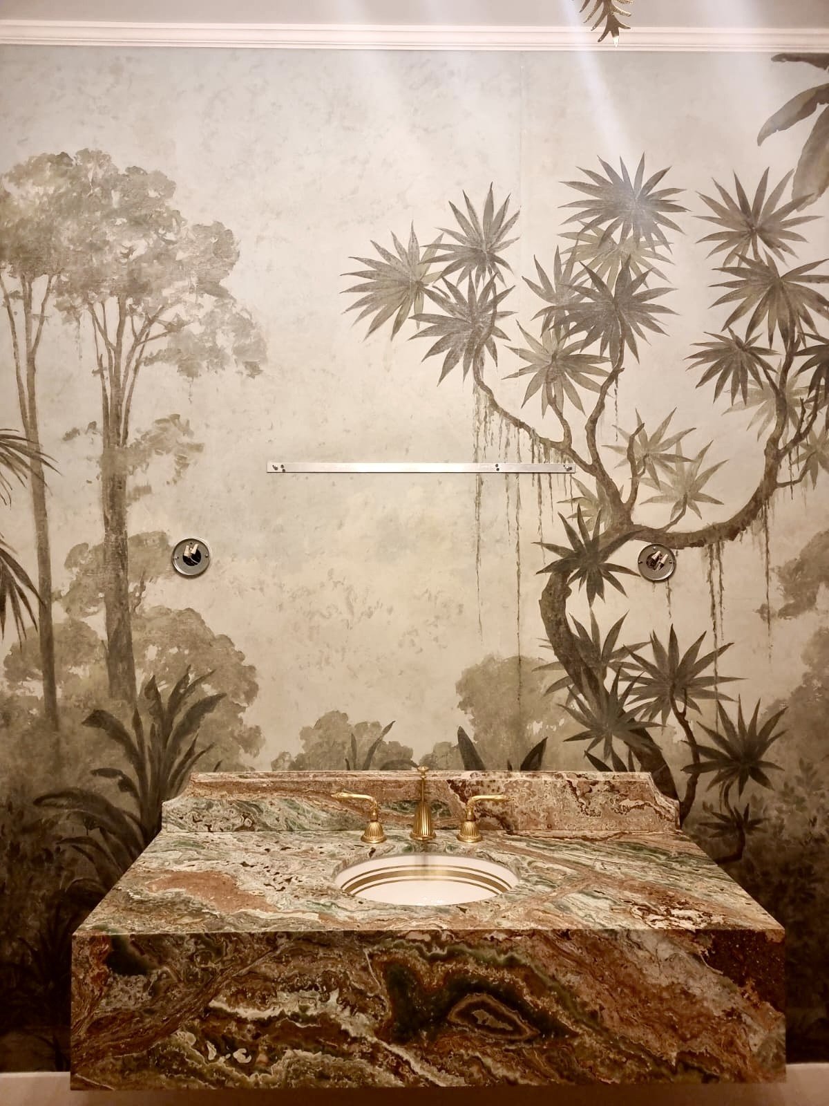 Marble vanity against a hand-painted jungle mural by Kim Delaney, Delaney Fine Finishes