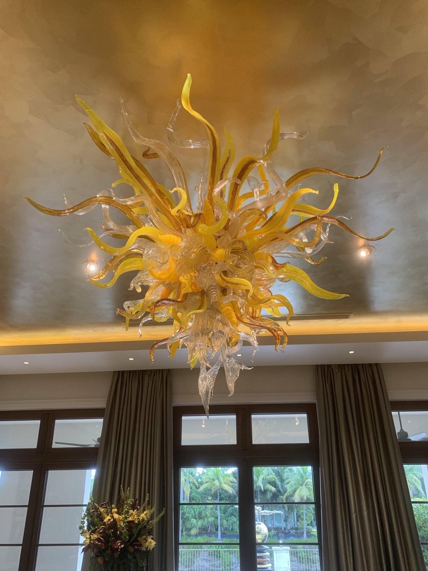 Amber blown-glass chandelier against a gold-leafed ceiling by Kim Delaney, Delaney Fine Finishes