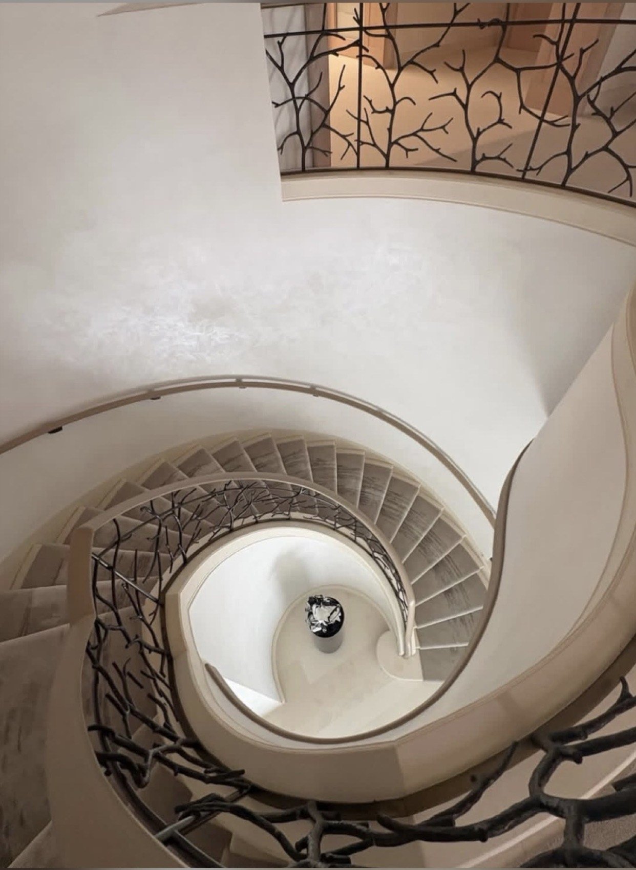 Spiral staircase with polished Venetian plaster walls by Kim Delaney, Delaney Fine Finishes