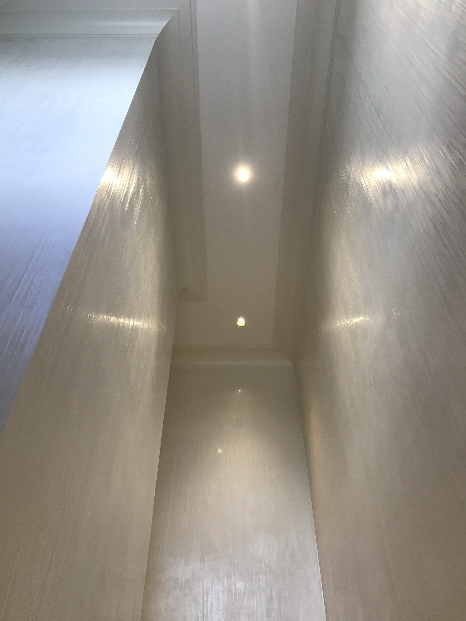 Striated polished plaster stairwell catching the light by Kim Delaney, Delaney Fine Finishes