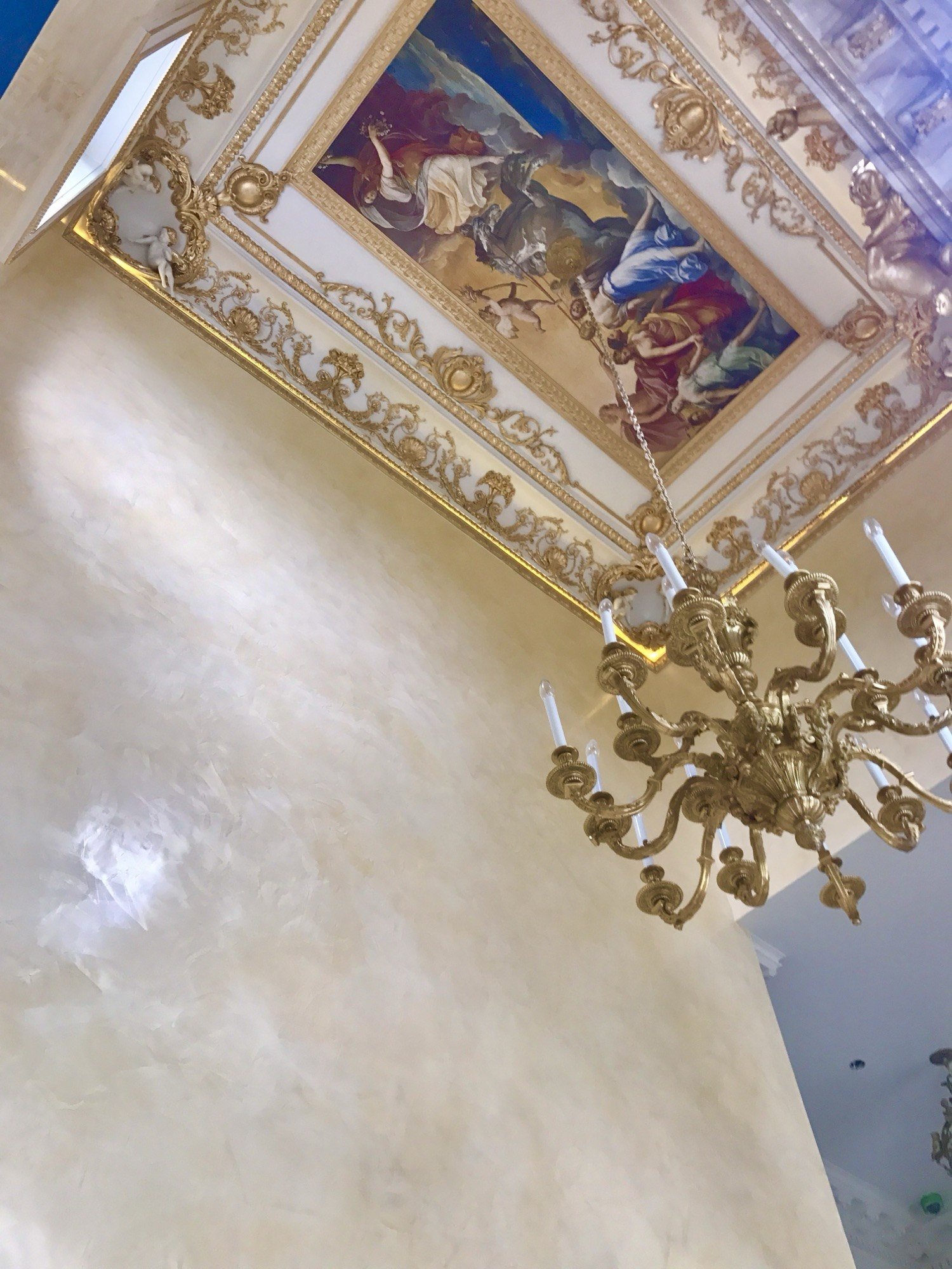 Polished ivory plaster wall rising to a gilded fresco ceiling by Kim Delaney, Delaney Fine Finishes