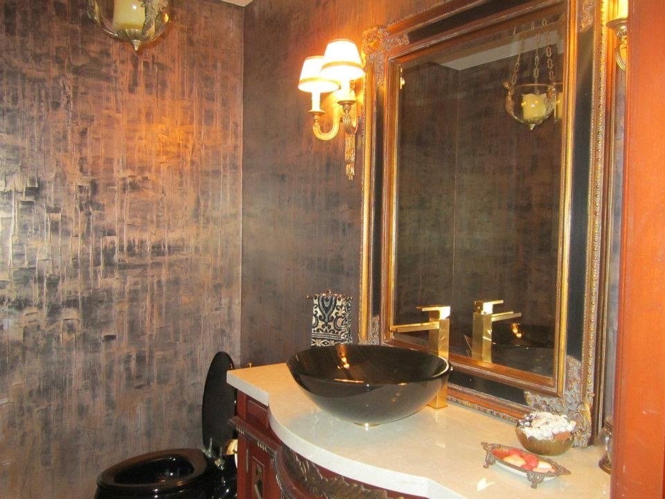 Powder room in bronze metallic textured plaster with gilded mirror by Kim Delaney, Delaney Fine Finishes