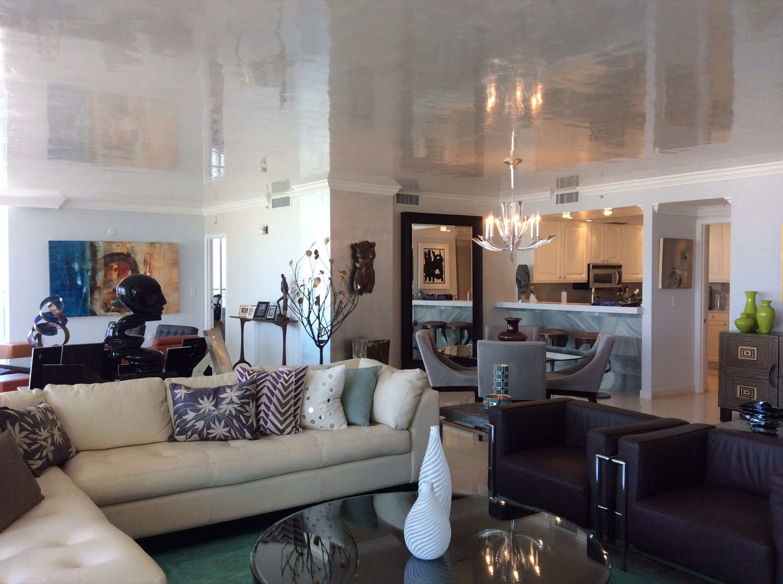 Mirror-gloss polished plaster ceiling across an open living room by Kim Delaney, Delaney Fine Finishes