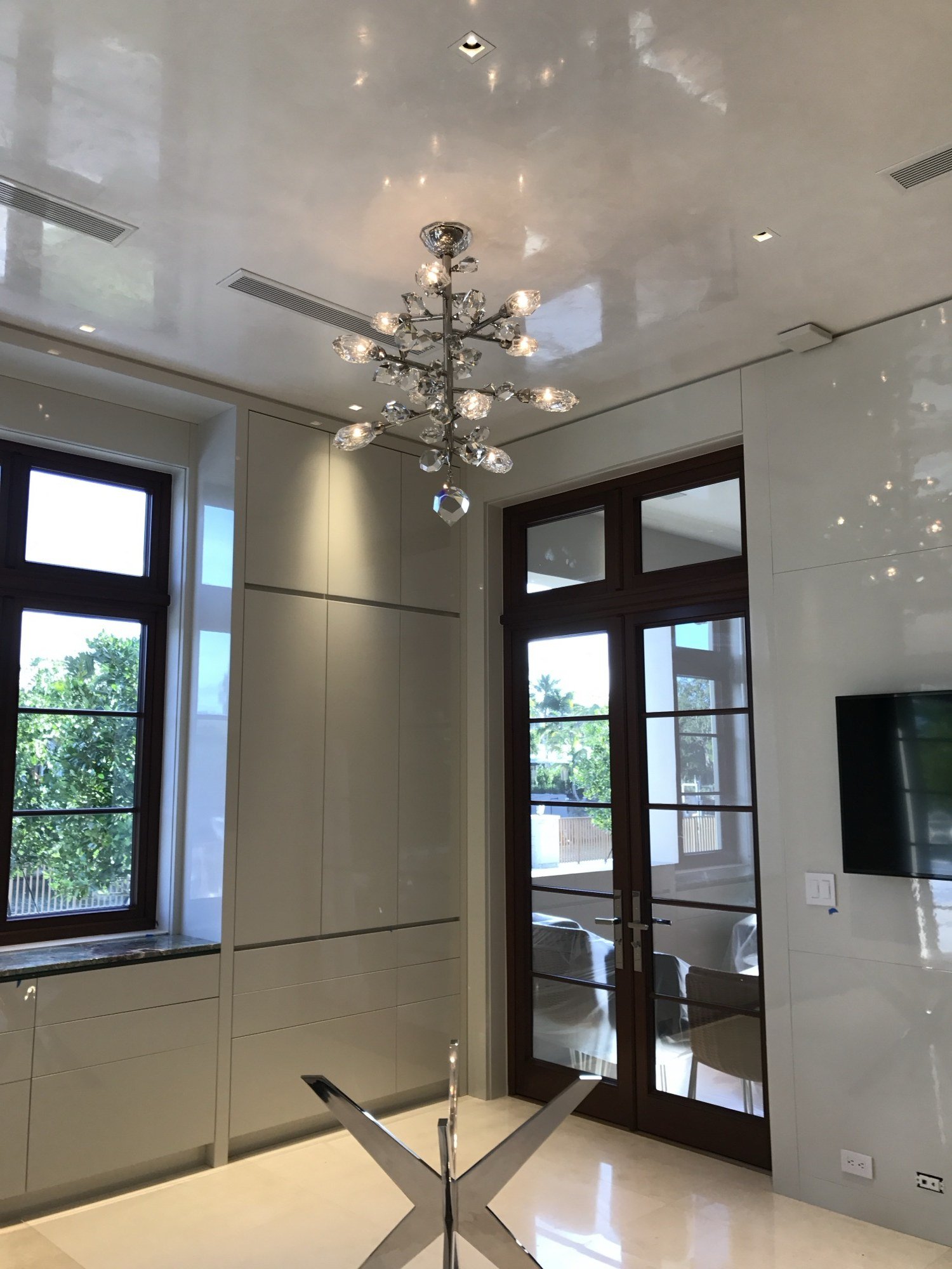 High-gloss polished plaster ceiling with glass chandelier by Kim Delaney, Delaney Fine Finishes