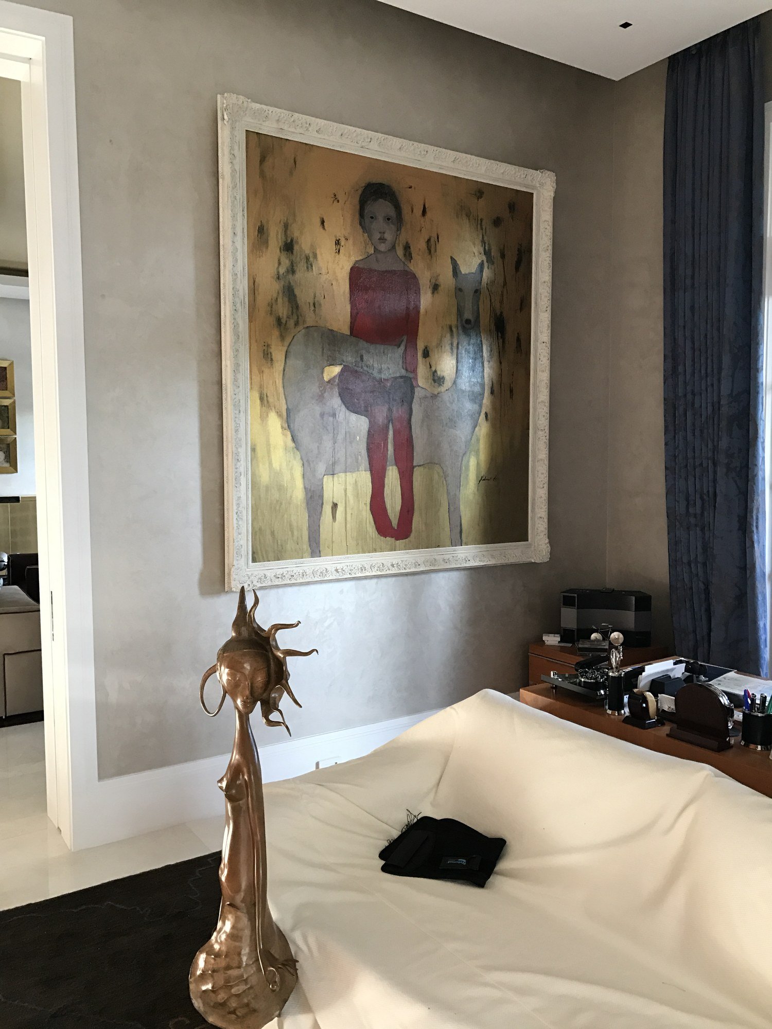 Taupe polished plaster bedroom wall behind a gold-ground painting by Kim Delaney, Delaney Fine Finishes