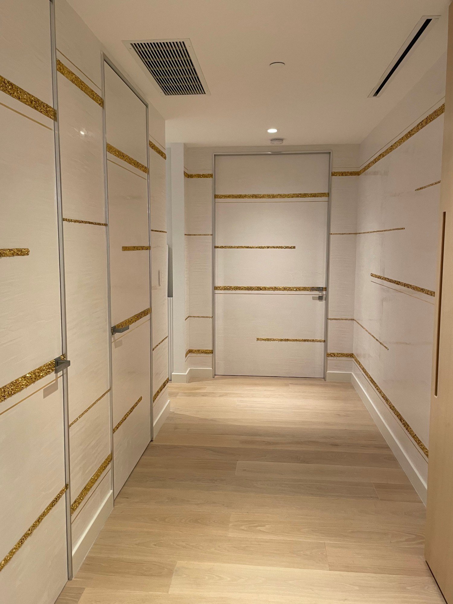 Textured plaster wall panels with gold-leaf inlay bands by Kim Delaney, Delaney Fine Finishes